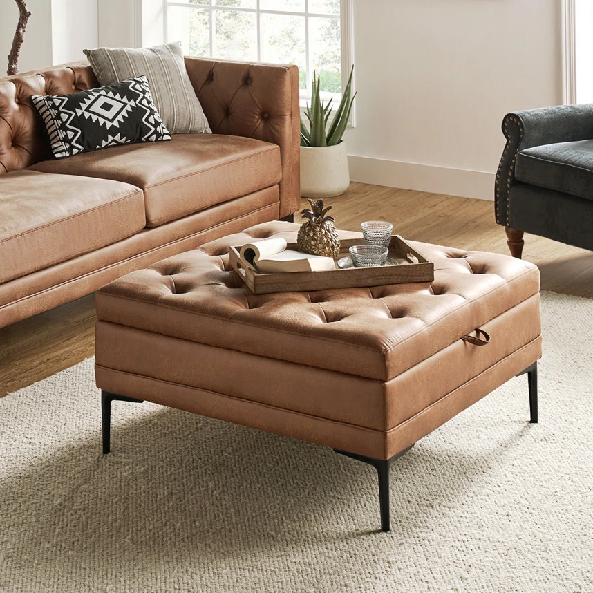 Tufted leather storage ottoman.