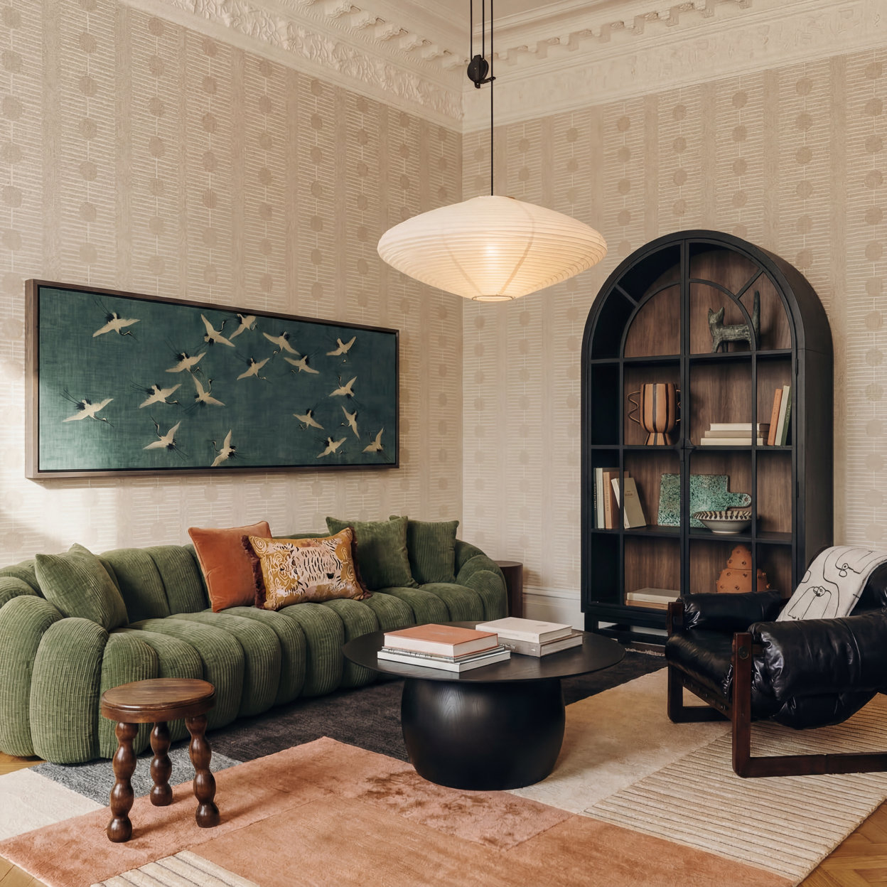 Vintage maximalist living room featuring a green curved sofa, crane artwork on t
