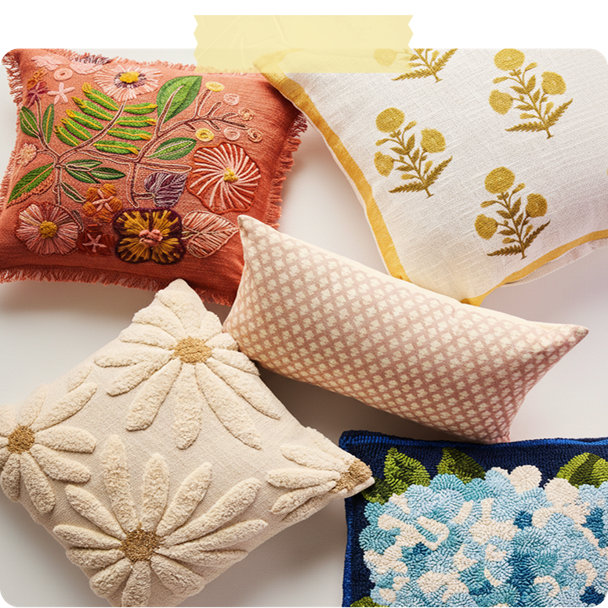 Assortment of decorative throw pillows with floral and botanical patterns