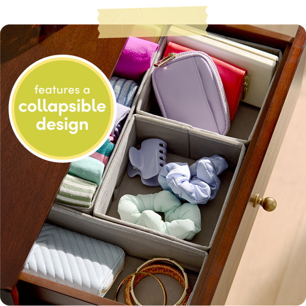 Open wooden dresser drawer with collapsible fabric storage organizers containing